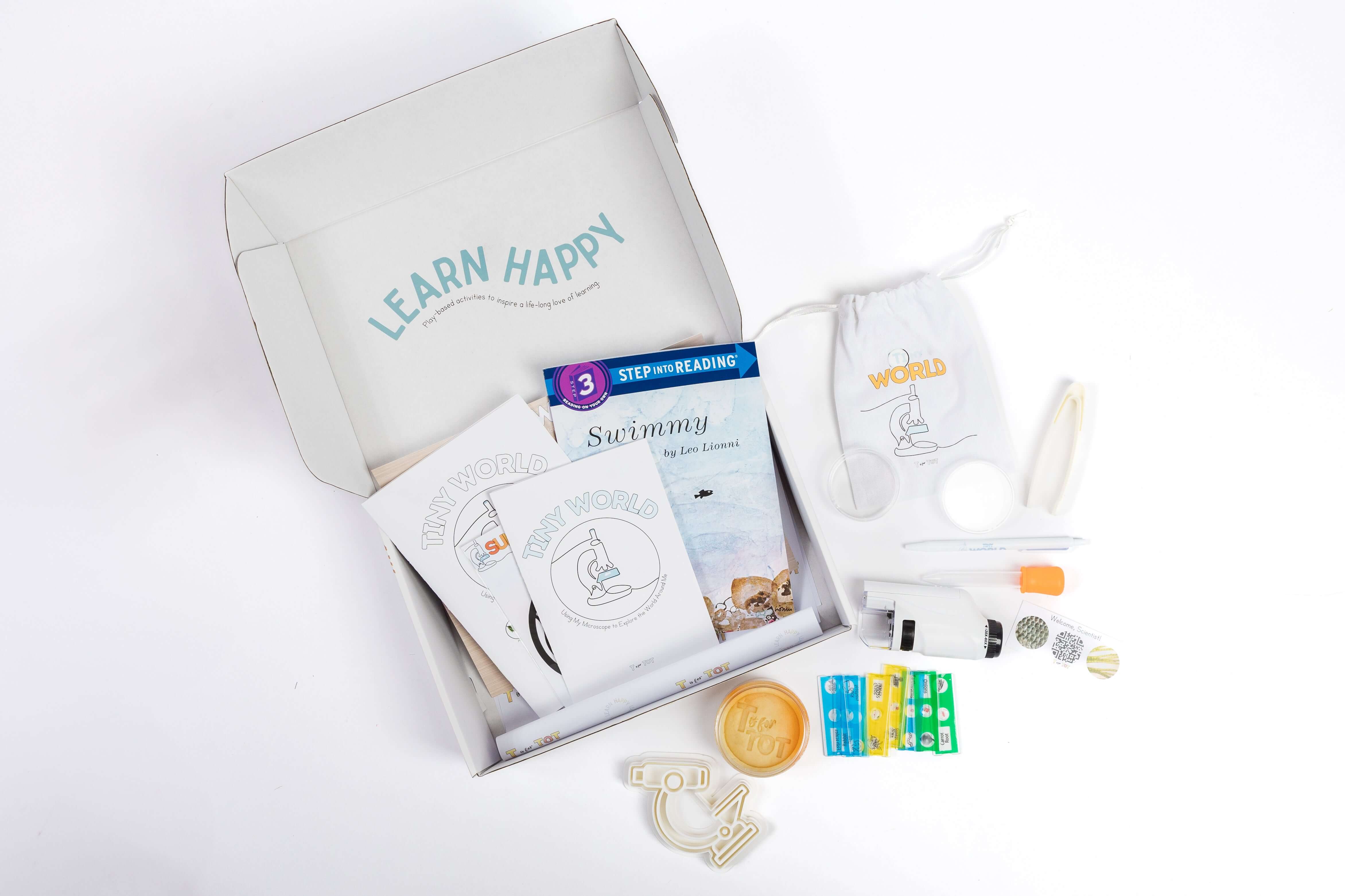 Tiny World Microscope Kit contents with microscope, specimen slides, activity cards, and tools